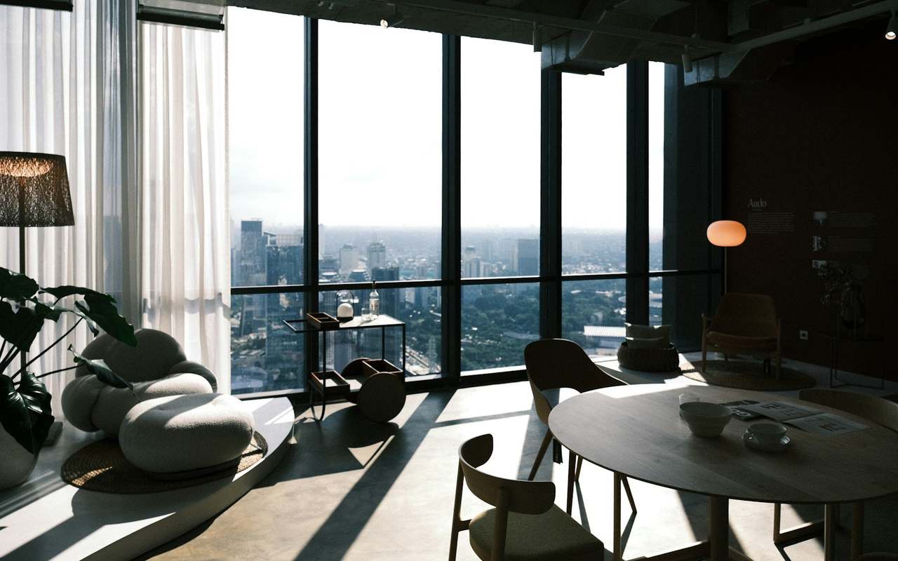 A quiet lounge high above the city, with floor-to-ceiling windows
